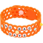 Customized orange bracelet with different charms that say no bad days