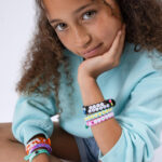 girl modeling her six completed bracelets