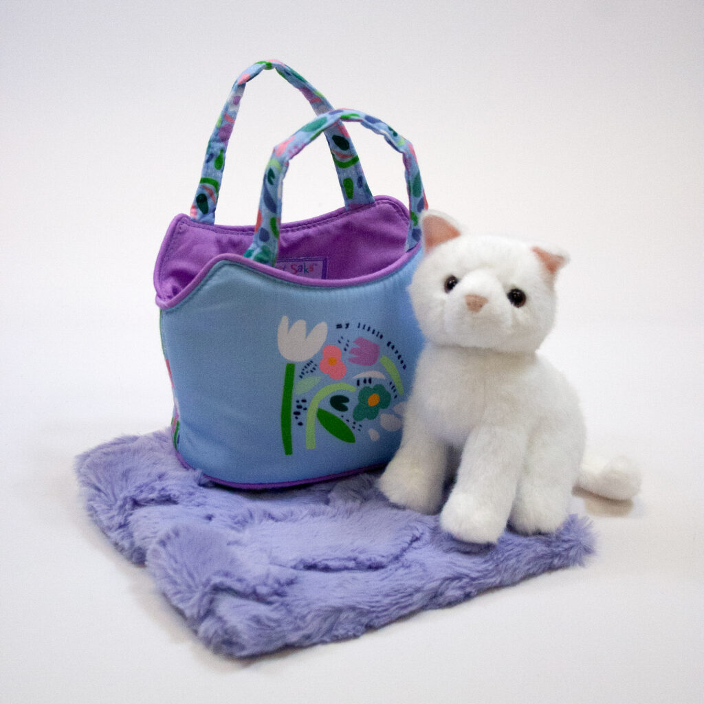 kitten smile sack has a solid white plush kitty and a blue-purple bag with floral design